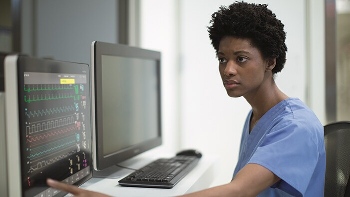 Health professional with patient monitor