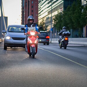 Moto and car on road